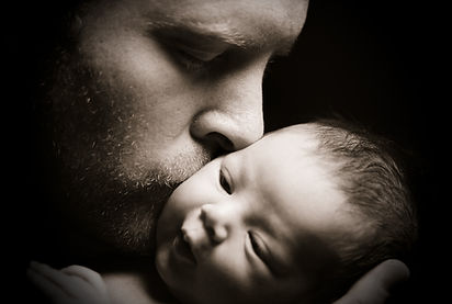 a man kissing a baby
