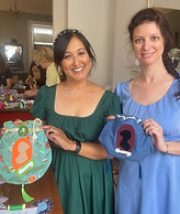 A woman in a green dress holding up the handmade green and orange reticule she has made in a creative workshop run by Make Creative Studio