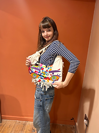 A teenage girl showing the bag she has made from an upcycled T-shirt