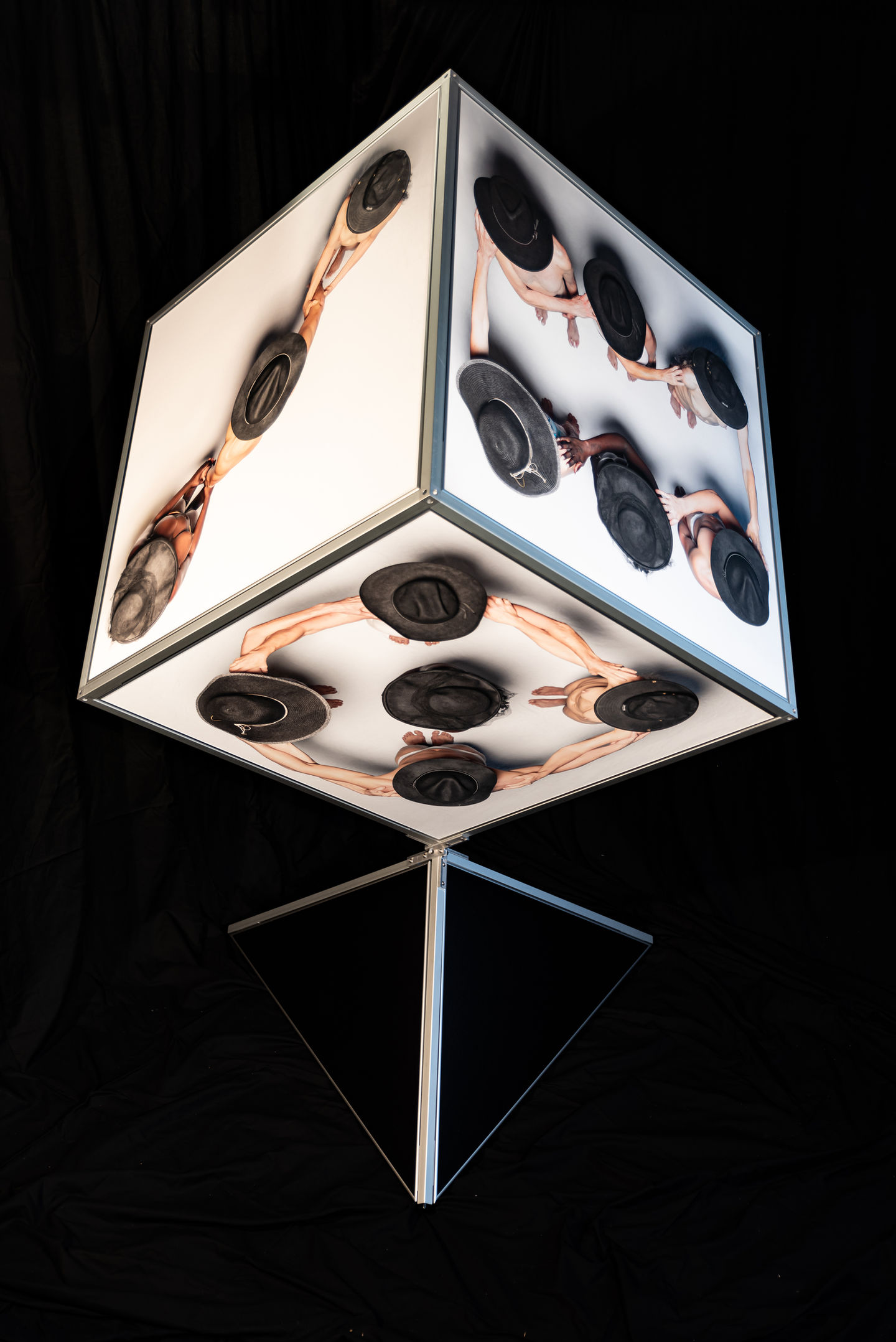 a cube with a picture of a woman and hats on it