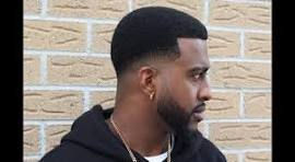 Low Fade haircut on a black man with a small afro haircut.