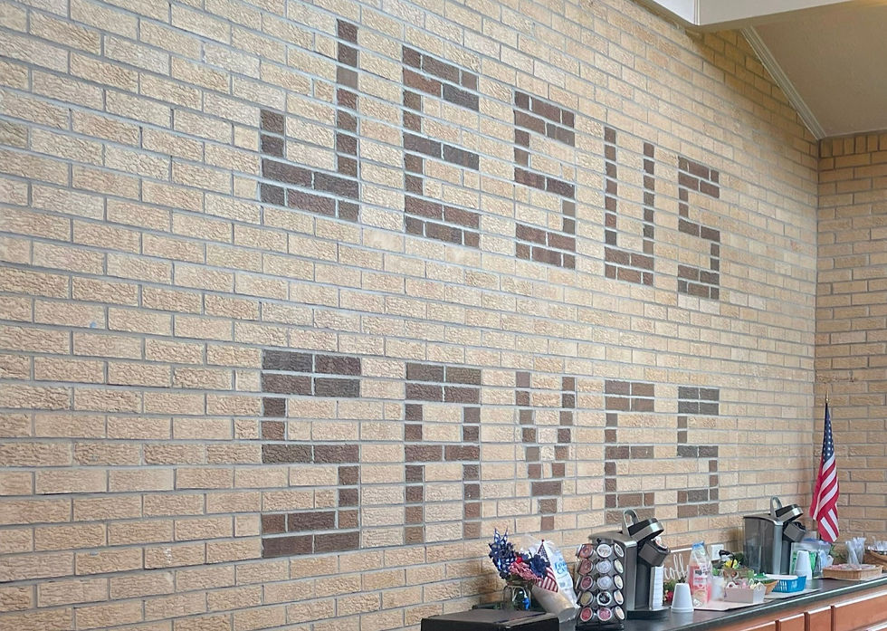 A picture of a brick wall that spells "Jesus Saves", explaining the similarity between all Protestant Denominations