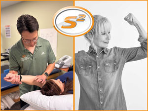 Physical therapist working on patient shoulder and confident woman