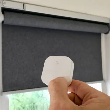 Smart blinds controlled with a handheld remote for light adjustment
