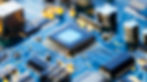 Close-up of a microchip on a blue printed circuit board with electronic components