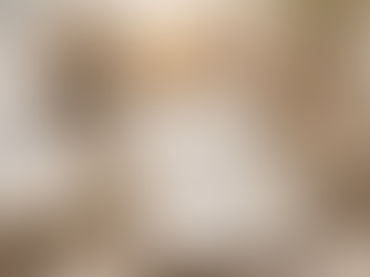 A woman writing affirmations in a journal at a sunlit desk with a Bible, candle, flowers, and a mug that says “Speak life,” creating a peaceful, reflective atmosphere.
