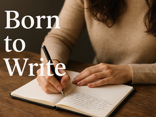 Hands writing in a notebook on a wooden table. Text "Born to Write" is visible on the left. Warm, cozy setting with a beige sweater.