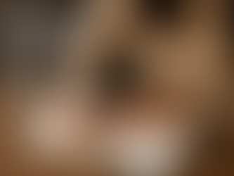 Hands writing in a notebook on a wooden table. Text "Born to Write" is visible on the left. Warm, cozy setting with a beige sweater.