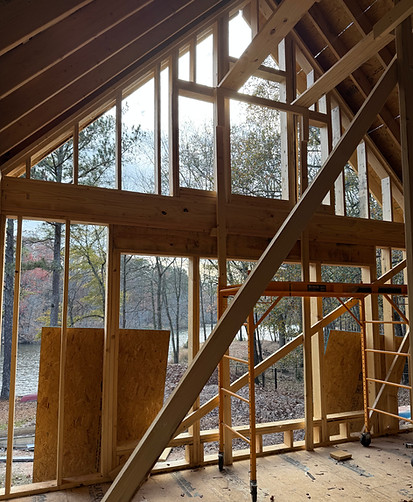 Cabin addition with large windows overlooking private lake in Jefferson County Georgia