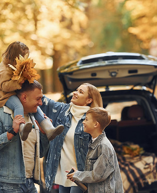 near-car-with-open-trunk-happy-family-is-park-autumn-time-together.jpg