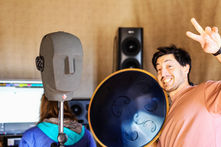 view of 432studios mastering room with people enjoying their recordings with an hangdrum and the neumann ku-100.