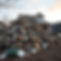 lets make a large pile of junk and debris center of the photo with a nice house behind it 