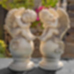 Cherubs Statues Sitting on Globe Pedestals