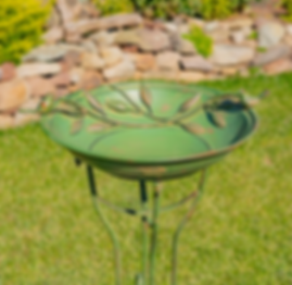 top view of green birdbath with two birds