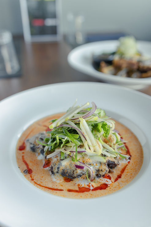 Tender slow-cooked beef cheek bathed in a rich, aromatic curry sauce, topped with a fresh and zesty green apple and red onion salad. Garnished with vibrant herbs and a drizzle of chilli oil, creating the perfect balance of savoury, creamy, and tangy flavours. A beautifully plated signature dish at Thai Station Restaurant.