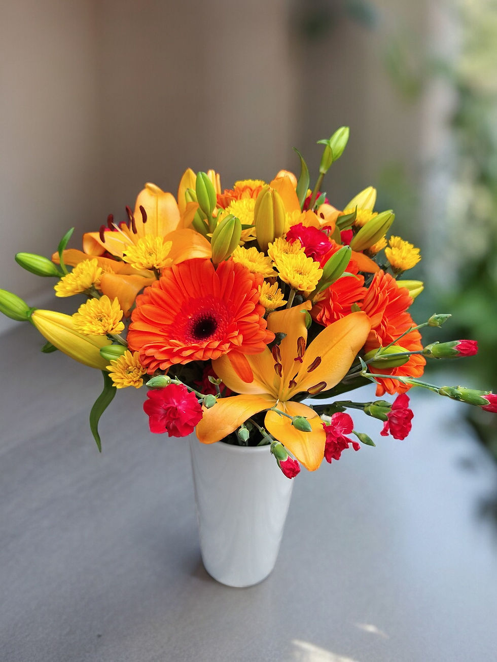 Orange/Yellow Mixed Bouquet in a re-usable ceramic vase