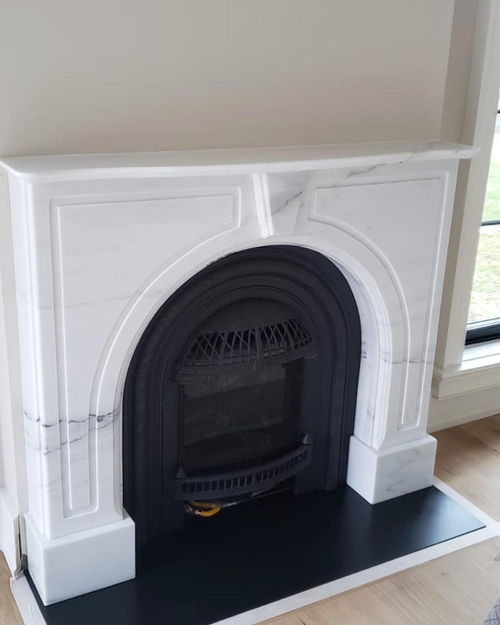 Exquisite white marble fireplace meticulously fabricated and intricately scored by Marble View Inc, adding timeless beauty and sophistication to any space.