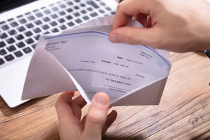 An accountant opening a check sent in the mail