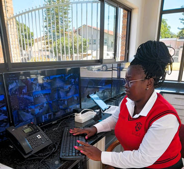 a female security guard monitoring CCTV at Lyon Security Cape Town