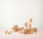 a pastel background of wooden toys make it lighter.jpg