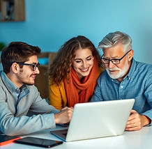 young guy helping older couple with tech