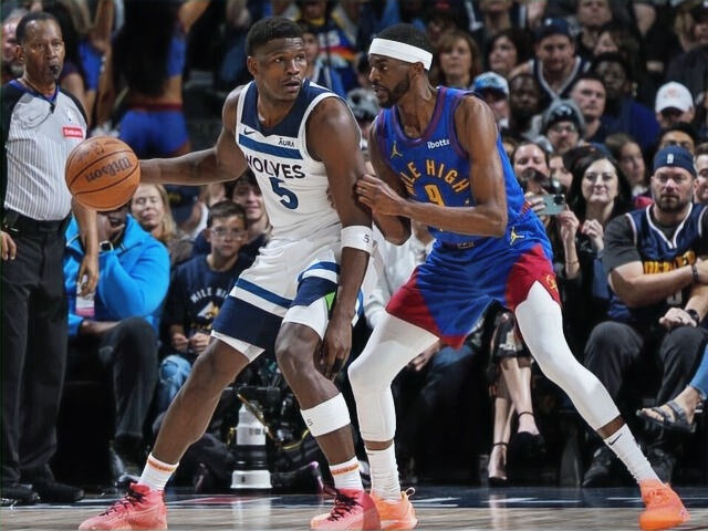 Anthony Edwards backing down Denver Nuggets forward Justin Holiday.