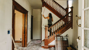 Renovation work inside a Victorian-style heritage home with original staircase.