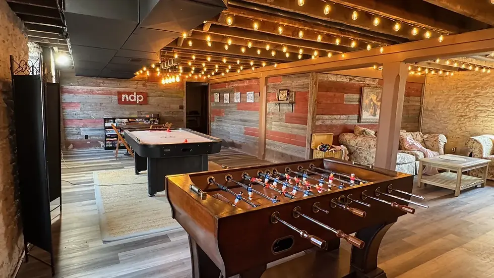 The student game room with a foosball table, air hockey table, and string lights