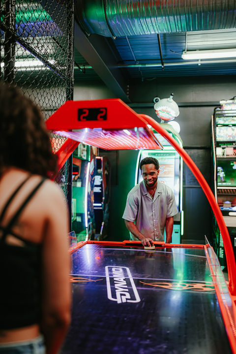 Friends playing arcade games.