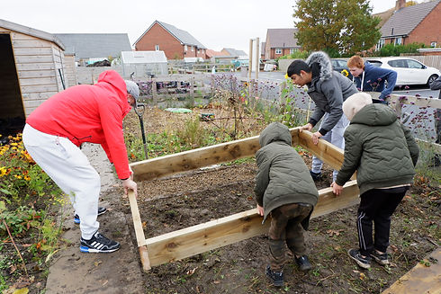 Placing one of the finished beds in place at Blakelaw Community Allotment.jpeg