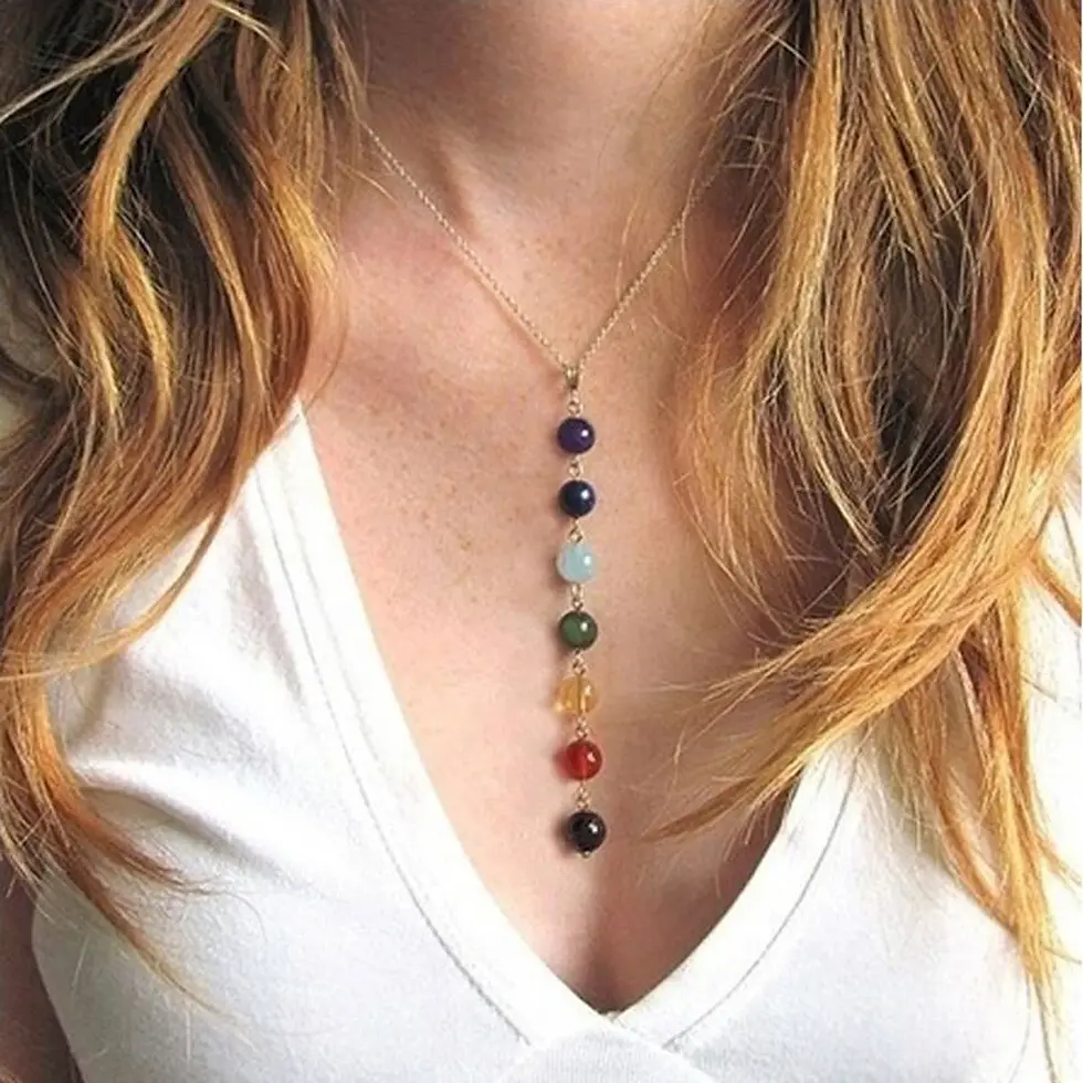 woman wearing chakra necklace
