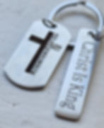 Keychains: dog tag with cross; bar reads 'Christ Is King'