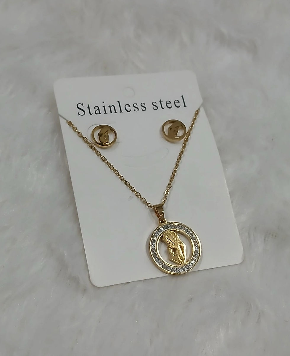 Gold Catholic necklace and earrings set in stainless steel, featuring a Virgin Mary pendant with crystal accents, displayed o