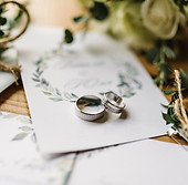 „Trauringe auf hochwertiger Hochzeitspapeterie als Symbol für Liebe und Verbundenheit.“
