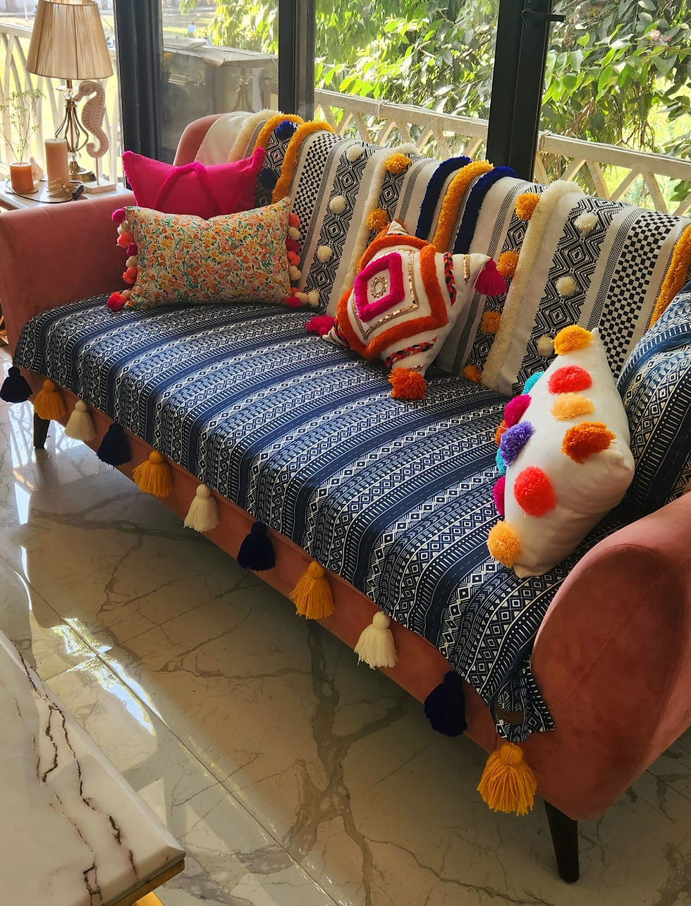 Close-up view of wool tufted work on the back of blue tribal printed sofa cover with multicolor tassels
