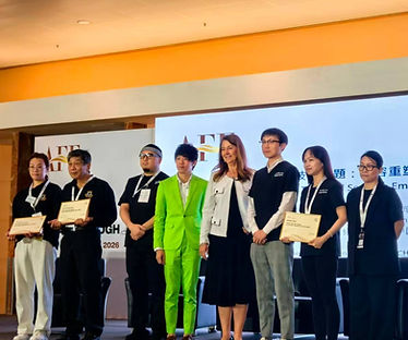 CHENG Man Hon, Nick in a bright green suit standing alongside event presenters and certificate recipients on stage at the Asia Funeral Expo (AFE).