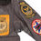 Thumbnail: An American brown leather bomber jacket with various cloth patches size 42