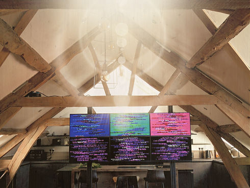 SyncWave light therapy system at EnergyWithin wellness centre in Ledbury, displaying vibrant coloured patterns on four screens, designed for relaxation, healing, and energy balance.