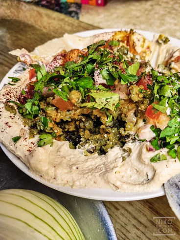 Deconstructed Falafel on Hummus with salad toppings
