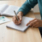 Student writing notes in notebook