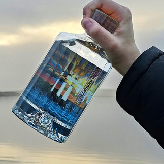Sule Skerry Gin held over an Orkney loch