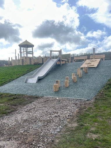 Wooden playground with slide and mulch safety surfacing