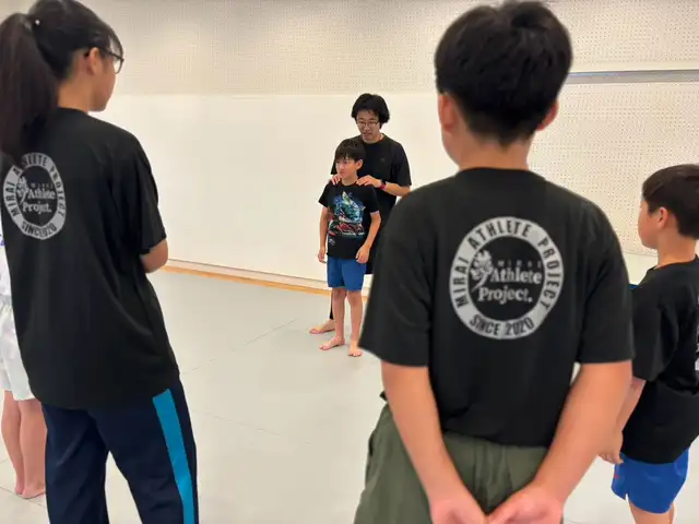 コーチと一緒に姿勢を確認する子どもたち（滋賀南草津校）