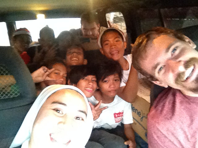 With the kids from the street on the way to visit their families