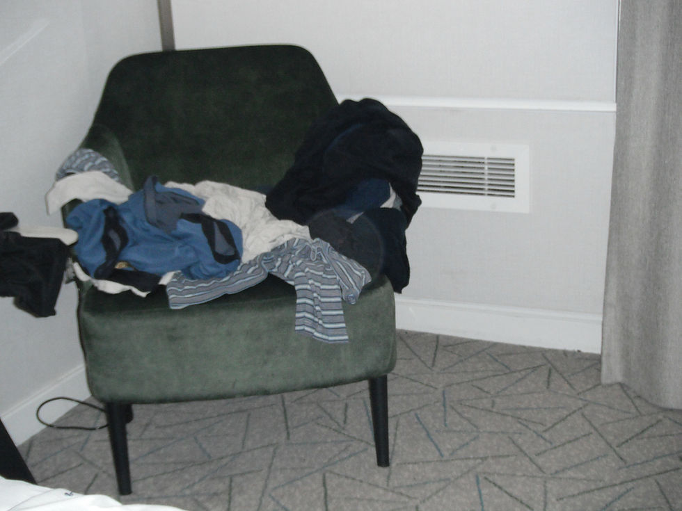 Some of my clothes heaped a chair for the Hilton Birmingham NEC hotel lack of dresser drawers