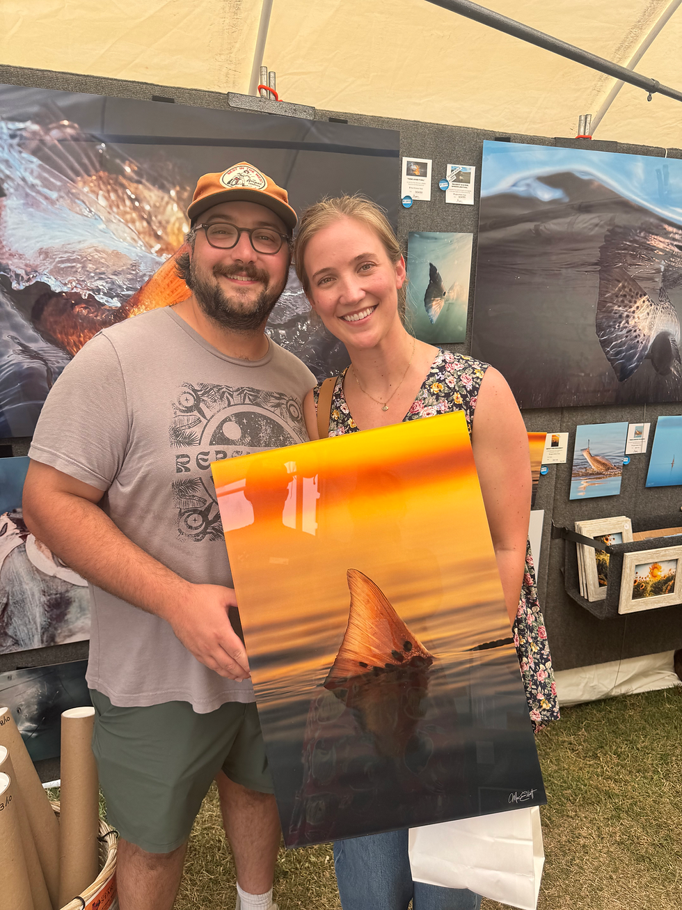 Art show patrons holding a MetalPrint