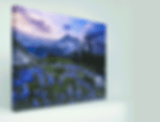 Canvas Print of a scenic mountain landscape with purple skies and vibrant blue wildflowers in the foreground, creating a serene mood.