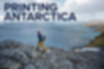 Max walks on rocky terrain by the ocean. Overcast sky, snow-capped mountains in distance. Rugged landscape mood.