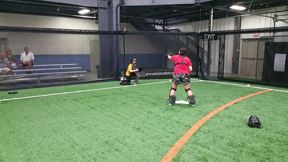 Baseball players practicing surrounded by a Specto indoor fencing system