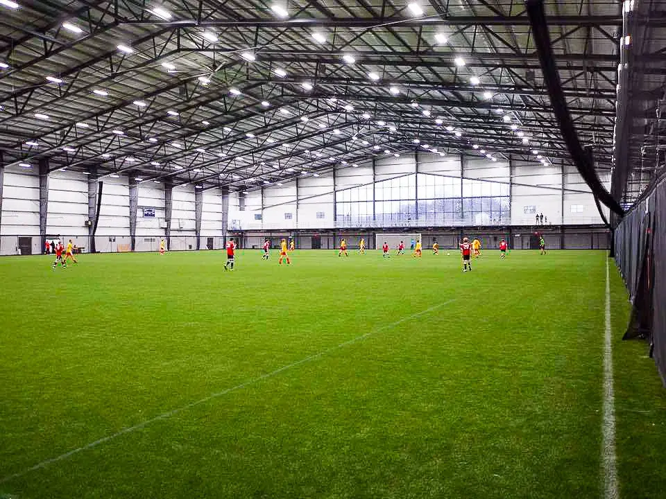 Indoor soccer players in game